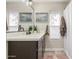 Bathroom featuring a vanity with a dark brown cabinet and white countertops and a framed painting at 6357 W Potter Dr, Glendale, AZ 85308