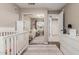 Bedroom featuring twin white cribs, closet with mirrored doors, and access to the Primary bedroom at 6357 W Potter Dr, Glendale, AZ 85308