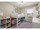 Bright bedroom with a loft bed over storage, a large window, and light neutral walls at 6357 W Potter Dr, Glendale, AZ 85308