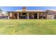 Enjoy an outdoor fireplace in this covered patio overlooking the lush backyard at 6357 W Potter Dr, Glendale, AZ 85308
