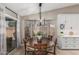 Charming dining room with a round wooden table and natural light from the sliding glass door at 6357 W Potter Dr, Glendale, AZ 85308