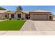 Charming single-story home featuring a well-manicured lawn and a two-car garage at 6357 W Potter Dr, Glendale, AZ 85308