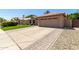 Inviting home exterior with a well-maintained lawn and a spacious two car garage at 6357 W Potter Dr, Glendale, AZ 85308