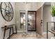 Inviting foyer features an eye-catching mirror, stylish table, and patterned rug at 6357 W Potter Dr, Glendale, AZ 85308