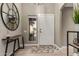 Bright foyer featuring a stylish mirror, modern table, and patterned rug at 6357 W Potter Dr, Glendale, AZ 85308