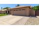 Spacious two-car garage with a well-kept driveway and landscaping at 6357 W Potter Dr, Glendale, AZ 85308