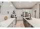 Modern kitchen with sleek white cabinets, stainless steel appliances, and a large island with a black sink at 6357 W Potter Dr, Glendale, AZ 85308