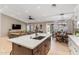 Open-concept kitchen features a large island with a sink, white countertops, and stainless steel appliances at 6357 W Potter Dr, Glendale, AZ 85308