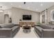 Cozy living room features a modern entertainment center and stylish sofas at 6357 W Potter Dr, Glendale, AZ 85308
