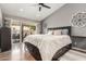 Spacious main bedroom with a sliding glass door to the outside, gray walls, and ceiling fan at 6357 W Potter Dr, Glendale, AZ 85308