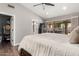 Cozy main bedroom with sliding glass doors to the patio, neutral decor, and hardwood floors at 6357 W Potter Dr, Glendale, AZ 85308