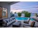Relaxing outdoor space with a comfortable seating area, fire pit, a sparkling pool, and a convenient bar for entertaining at 6450 E Vernon Ave, Scottsdale, AZ 85257