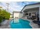 Backyard oasis showcasing a pool, inviting patio, outdoor bar and relaxing fire feature at 6450 E Vernon Ave, Scottsdale, AZ 85257