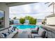 Backyard oasis featuring a sparkling pool, comfortable seating, and an outdoor bar area at 6450 E Vernon Ave, Scottsdale, AZ 85257