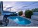 Inviting backyard pool and spa area with lush landscaping, fire pit, and stylish patio furniture at 6450 E Vernon Ave, Scottsdale, AZ 85257