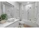 Bright bathroom featuring modern tile, vessel sink, and bathtub with glass doors at 6450 E Vernon Ave, Scottsdale, AZ 85257