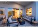 Spacious covered patio featuring comfortable seating, a modern ceiling fan, and an inviting indoor-outdoor living space at 6450 E Vernon Ave, Scottsdale, AZ 85257