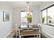 Charming dining area with a view of the pool, featuring modern lighting and comfortable seating at 6450 E Vernon Ave, Scottsdale, AZ 85257