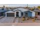 Inviting home exterior with modern curb appeal, xeriscape landscaping, and a spacious driveway at 6450 E Vernon Ave, Scottsdale, AZ 85257