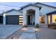 Stunning home featuring a modern design, gray brick pathway, and a sleek garage door with horizontal window accents at 6450 E Vernon Ave, Scottsdale, AZ 85257