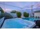 Inviting backyard showcasing a luxurious hot tub and pool, complemented by cozy seating and landscape for relaxation at 6450 E Vernon Ave, Scottsdale, AZ 85257