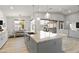 Bright kitchen featuring a granite island, backyard views, and modern light fixtures at 6450 E Vernon Ave, Scottsdale, AZ 85257