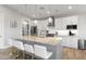 Beautiful kitchen with a granite island, stainless steel appliances, and sleek white cabinetry at 6450 E Vernon Ave, Scottsdale, AZ 85257