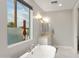 Well-lit main bathroom featuring soaking tub and marble countertops create a serene space at 6450 E Vernon Ave, Scottsdale, AZ 85257