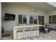 Outdoor bar with counter seating, grill and tv is ideal for entertaining in the backyard at 6450 E Vernon Ave, Scottsdale, AZ 85257
