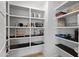 Well-organized pantry with white shelving offers ample storage space for food and kitchen essentials at 6450 E Vernon Ave, Scottsdale, AZ 85257