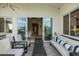 Spacious patio featuring comfortable seating, a modern coffee table, and seamless indoor-outdoor living at 6450 E Vernon Ave, Scottsdale, AZ 85257