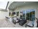 Inviting patio area with comfortable seating, an outdoor bar, and serene backyard views at 6450 E Vernon Ave, Scottsdale, AZ 85257
