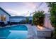 Tranquil backyard featuring a beautiful pool, hot tub, and a cozy fire pit, ideal for relaxing and entertaining guests at 6450 E Vernon Ave, Scottsdale, AZ 85257