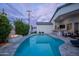 Stunning outdoor oasis with a sparkling pool, fire pit, and bar area, perfect for relaxing and entertaining guests at 6450 E Vernon Ave, Scottsdale, AZ 85257