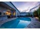 Captivating backyard featuring a sparkling pool, cozy fire pit, and convenient bar area, perfect for outdoor relaxation at 6450 E Vernon Ave, Scottsdale, AZ 85257