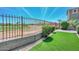 View of the backyard with artificial grass and a fence overlooking a golf course at 6611 S San Jacinto St, Gilbert, AZ 85298