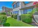 View of the backyard of the home with manicured landscaping and green artificial grass at 6611 S San Jacinto St, Gilbert, AZ 85298