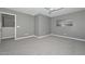 This spacious bedroom features soft gray walls, plush carpeting, and neutral decor at 6611 S San Jacinto St, Gilbert, AZ 85298