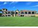 Elegant clubhouse on a golf course, featuring covered patios and beautiful landscaping at 6611 S San Jacinto St, Gilbert, AZ 85298