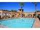 Community pool area with shade structures, seating, and desert landscaping at 6611 S San Jacinto St, Gilbert, AZ 85298