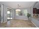 Light-filled dining room with tile floors, sliding glass doors, and access to the backyard at 6611 S San Jacinto St, Gilbert, AZ 85298