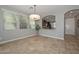 Dining area featuring tile flooring, bright windows, and views to the kitchen at 6611 S San Jacinto St, Gilbert, AZ 85298