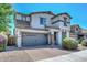 Attractive two-story home boasts stone accents, a two-car garage, and a well-kept brick driveway at 6611 S San Jacinto St, Gilbert, AZ 85298