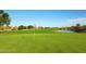 Picturesque golf course with a lake and lush green fairway at 6611 S San Jacinto St, Gilbert, AZ 85298