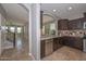 Spacious kitchen with dark wood cabinetry, granite countertops, and stainless steel appliances at 6611 S San Jacinto St, Gilbert, AZ 85298