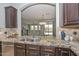 Modern kitchen featuring granite countertops, stainless steel appliances, and an open layout with views of the backyard at 6611 S San Jacinto St, Gilbert, AZ 85298
