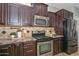 Elegant kitchen featuring stainless steel appliances, and warm wood cabinetry at 6611 S San Jacinto St, Gilbert, AZ 85298