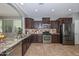Gourmet kitchen features granite counters, stainless steel appliances, and travertine floors at 6611 S San Jacinto St, Gilbert, AZ 85298