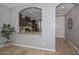 Arched opening offers view of kitchen with granite counters and stainless steel appliances at 6611 S San Jacinto St, Gilbert, AZ 85298