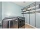 Convenient laundry room equipped with modern washer and dryer with ample shelving storage at 6611 S San Jacinto St, Gilbert, AZ 85298